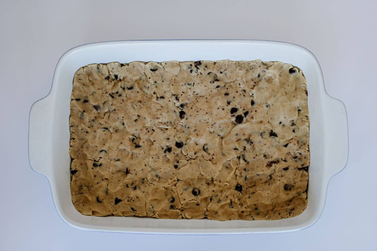 Step 2 - Chocolate Chip Cookie Bars spread out in baking pan