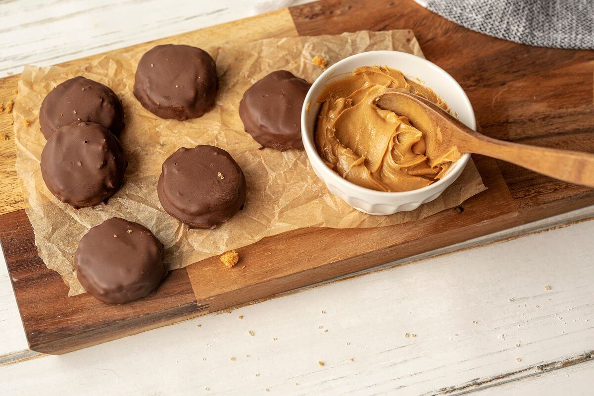 Finished Peanut Butter Patties on serving platter next to bowl of peanut butter