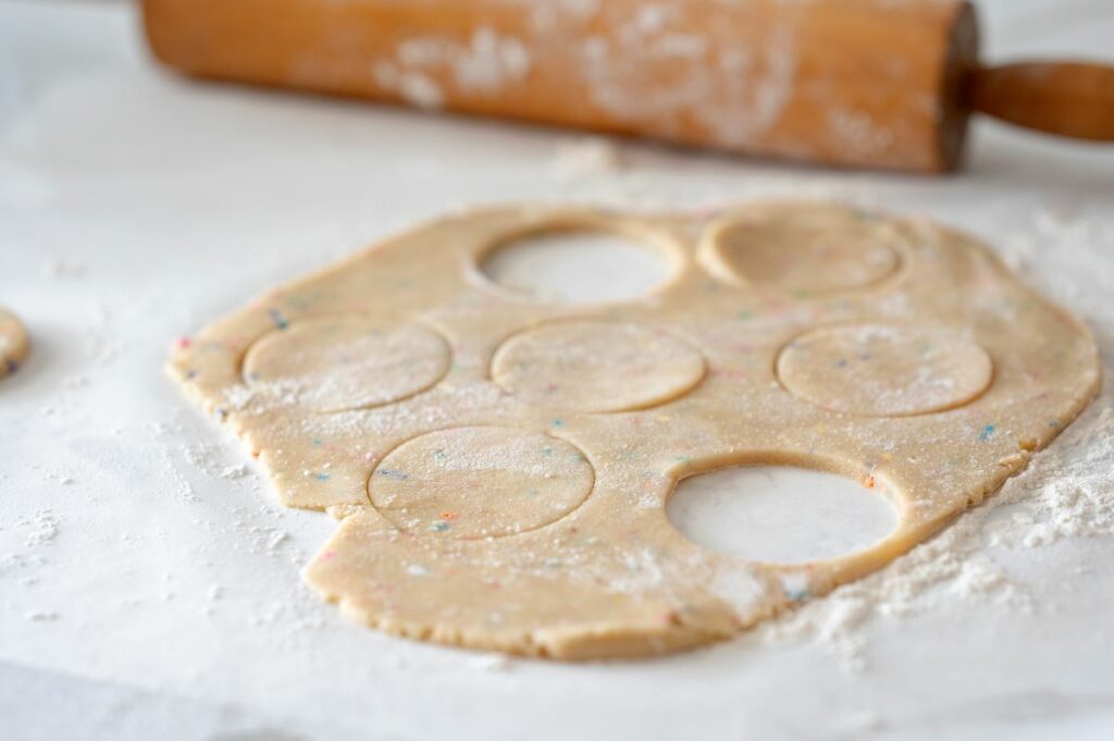 Step 1 and part of Step 2 - rolled out confetti cookie dough with large circles out into it.